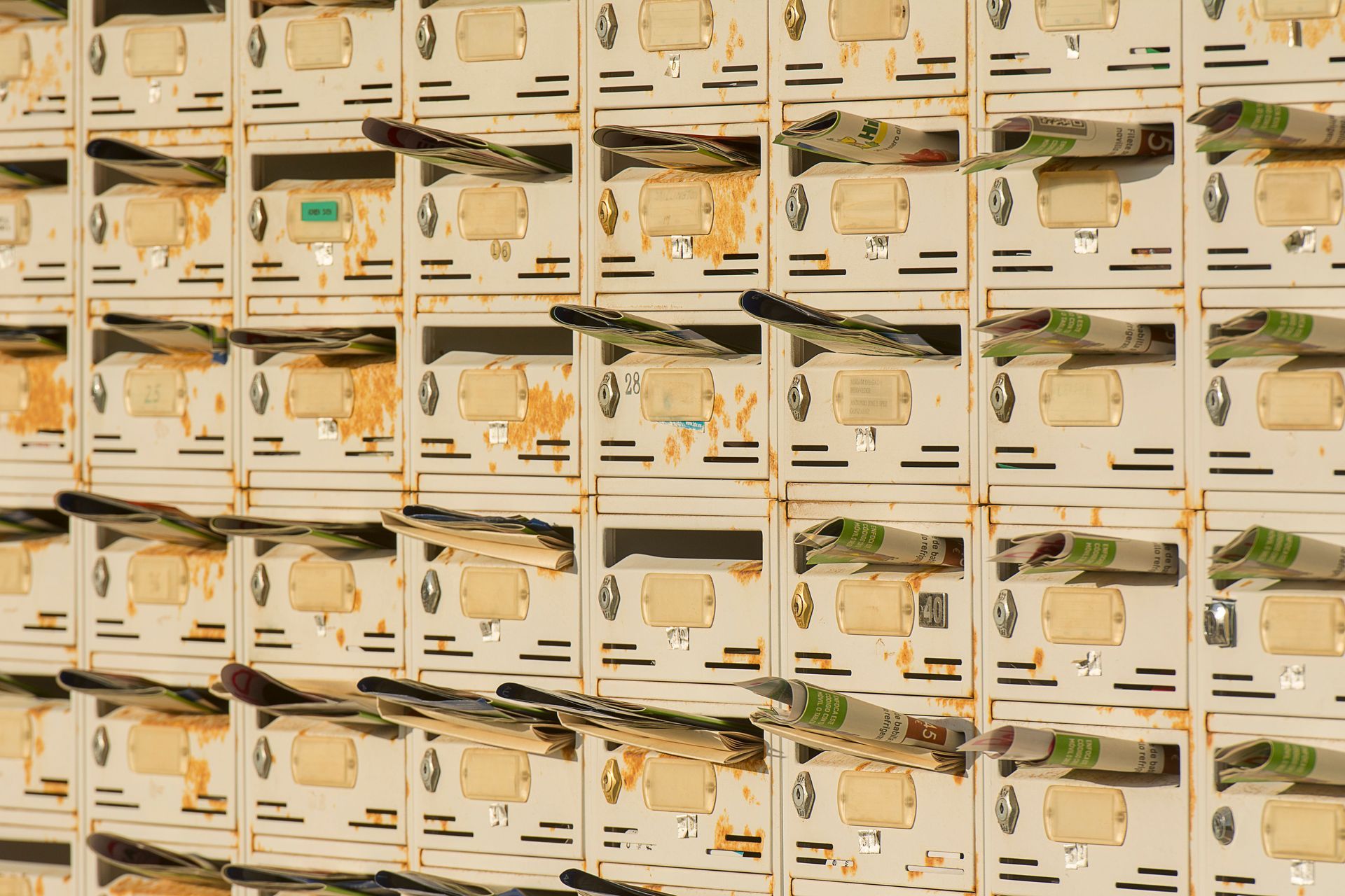 Rows of beige storage boxes with small items and labels on display shelves
