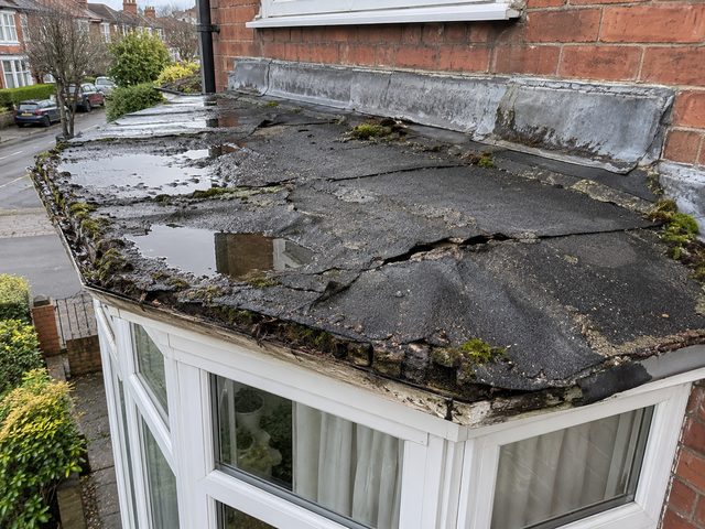 Bay window roof with cracked felt holding water