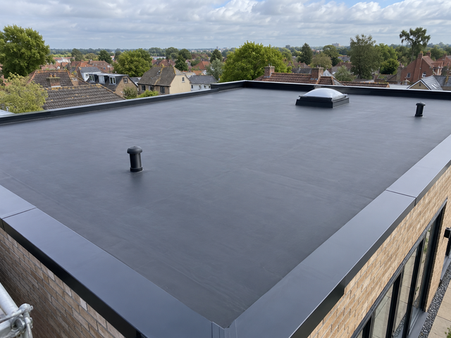 New EPDM rubber flat roof with a roof dome and metal edge trims
