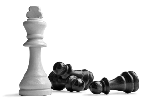 A white chess king is standing next to a pile of black chess pieces.