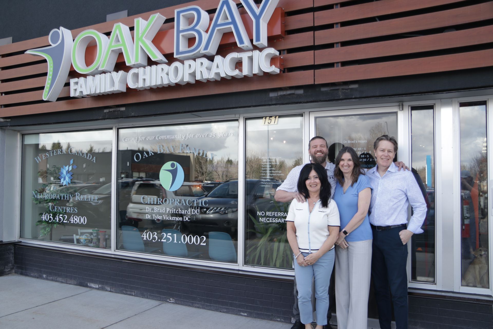 A group of people standing in front of a chiropractic office.