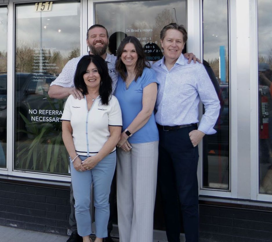 A group of people standing in front of a building that says no referral necessary