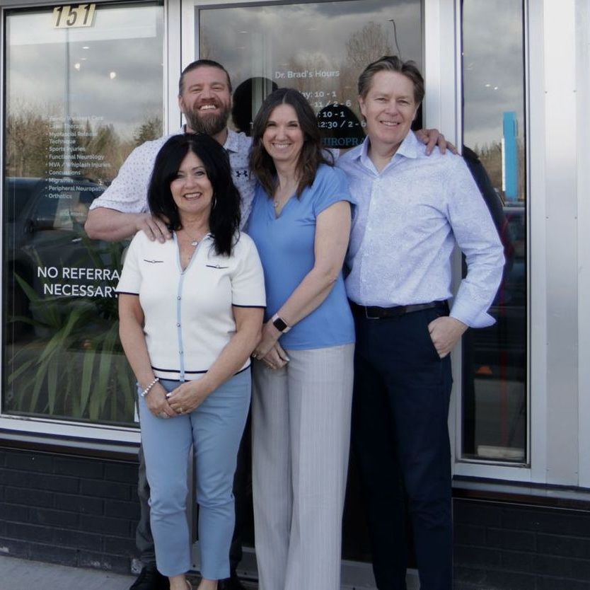 A group of people standing in front of a building that says no referral necessary