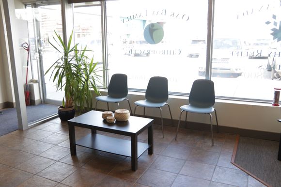 A waiting room with chairs and a coffee table