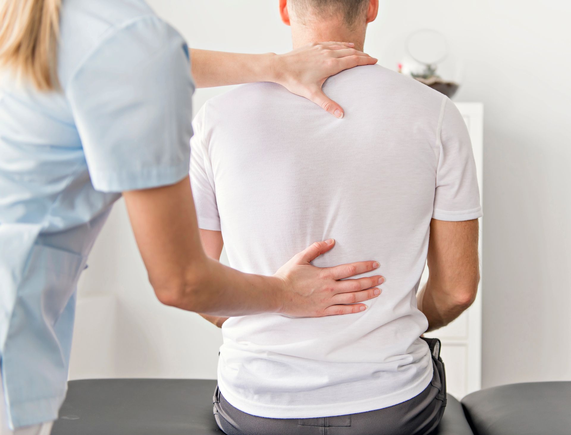 Chiropractor using functional neurology techniques on a clients back