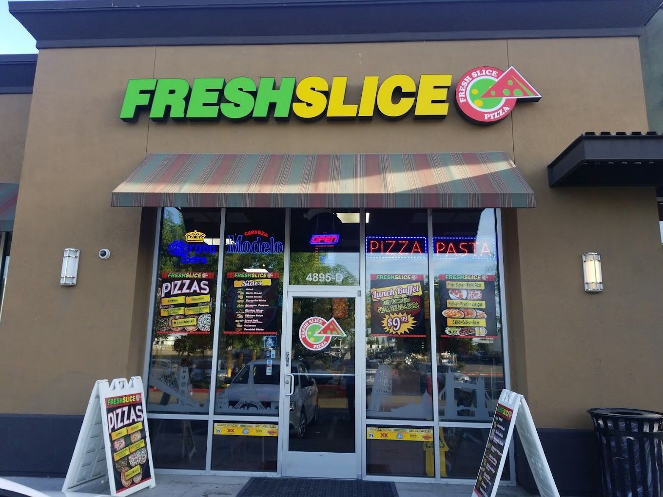 The front of a fresh slice pizza restaurant