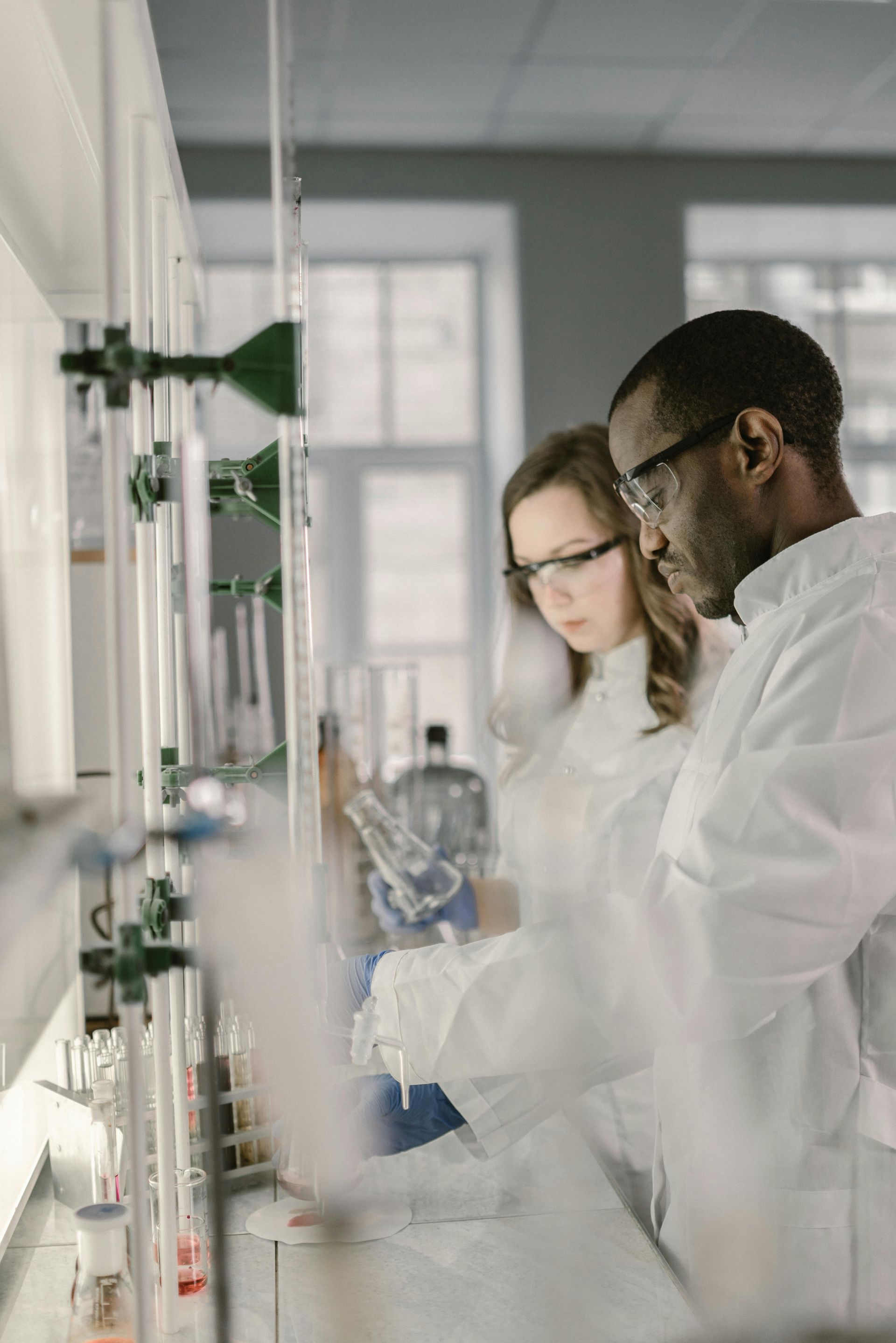 A man and a woman are working in a lab.
