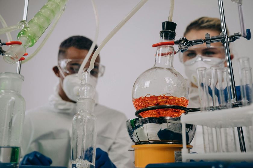 A man and a woman are working in a lab.