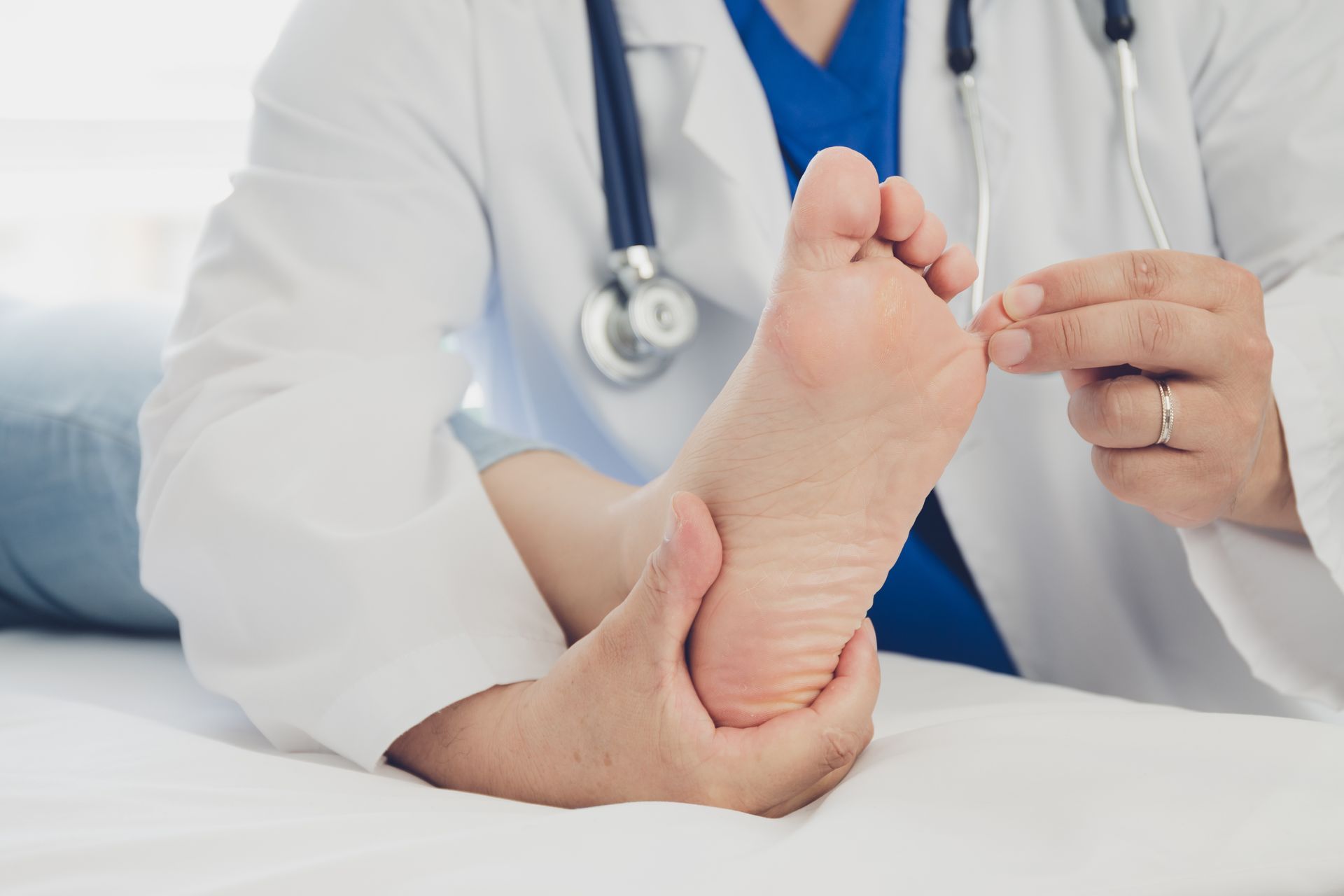Podiatry physicians performing detailed foot exam to assess pain, circulation, and skin health.