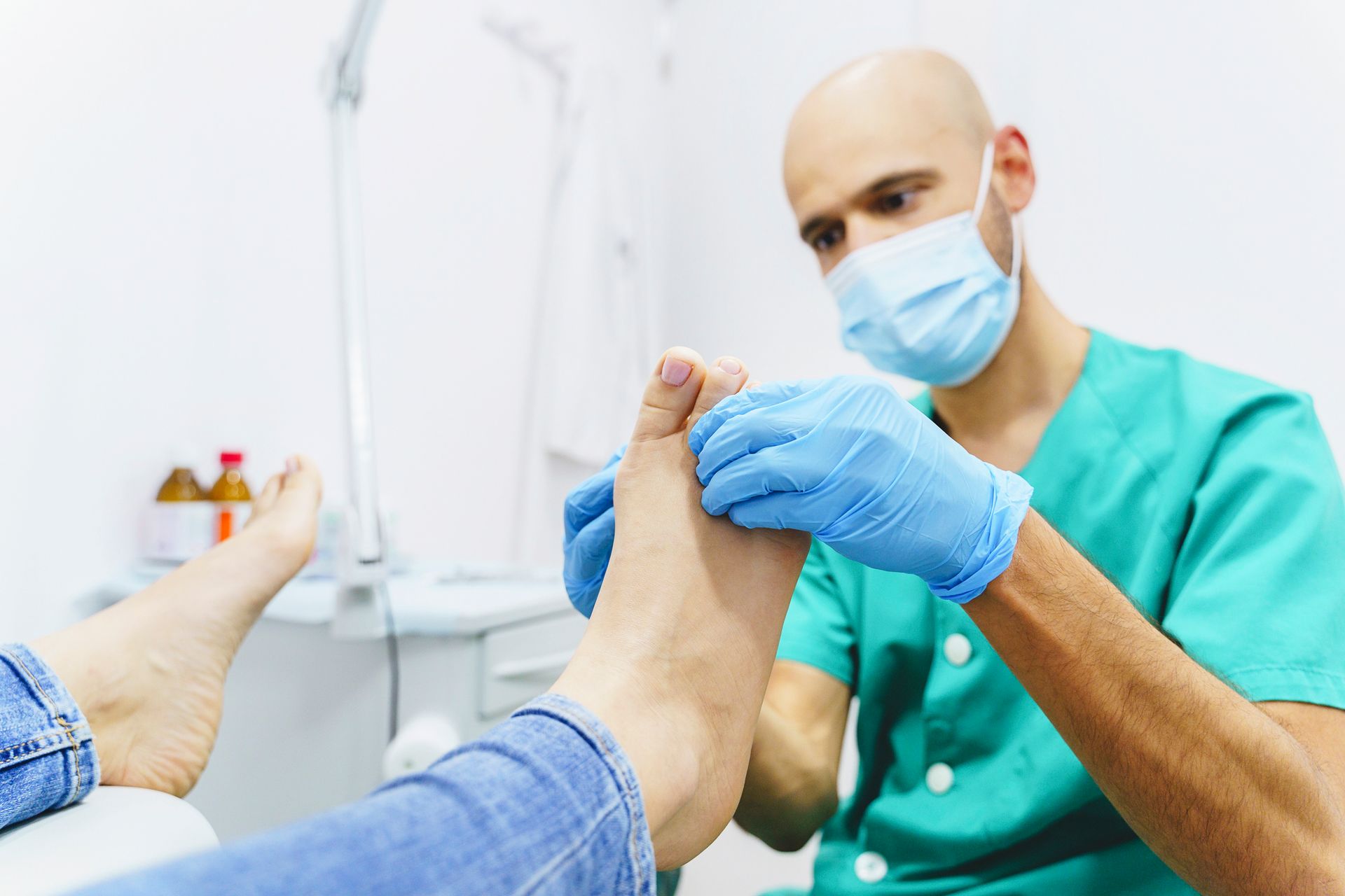 Portrait of a podiatrist working with a young woman patient.