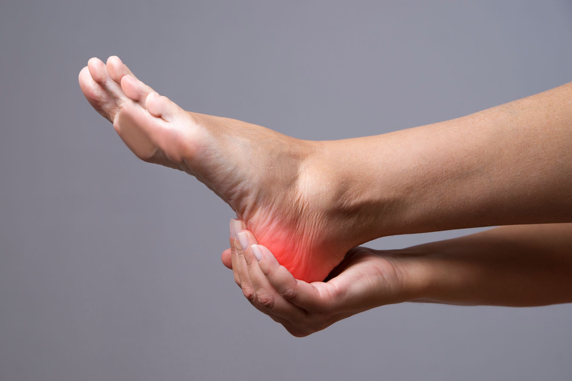 A close-up image of a person's foot with visible redness around the heel area | Podiatry Physicians