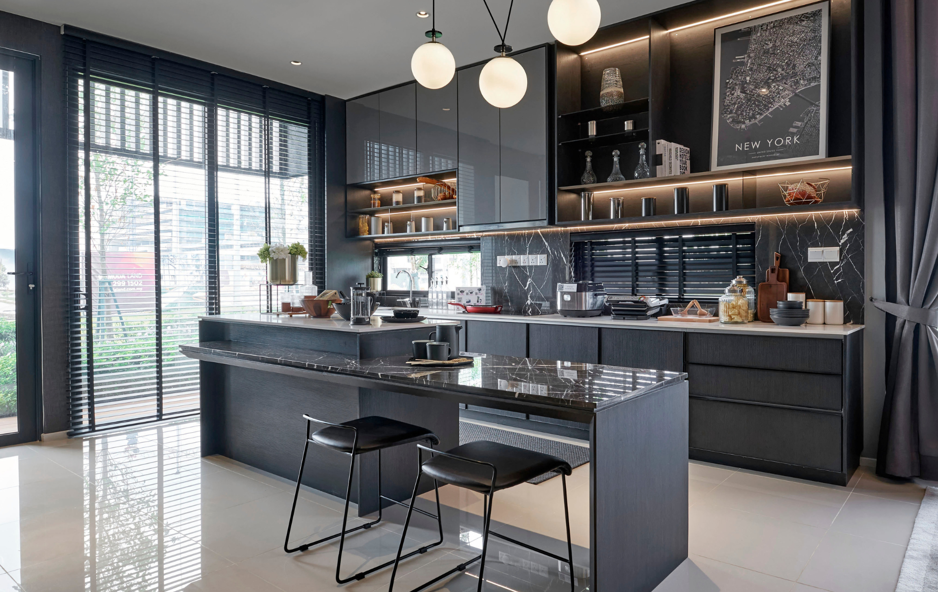 Modern gray kitchen with island and bar stools, floor-to-ceiling windows, and overhead lighting.