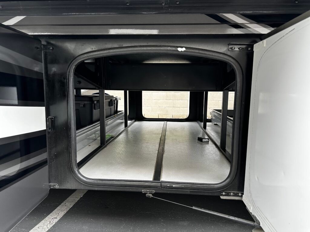 The inside of a rv with the door open.