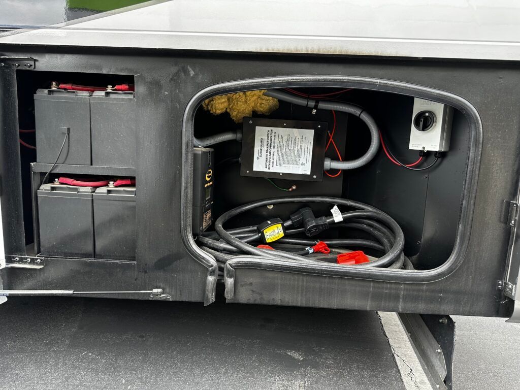 The inside of a vehicle with a bunch of wires and batteries