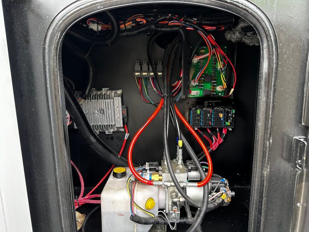 The inside of a vehicle with a lot of wires coming out of it