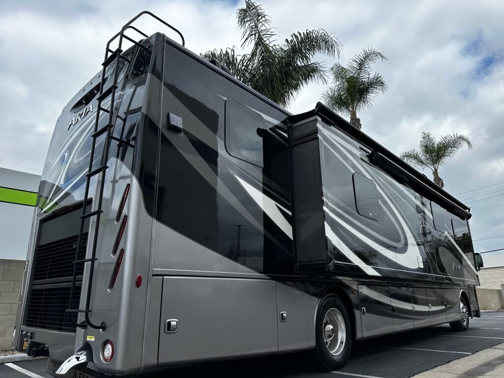 A large rv is parked on the side of the road.