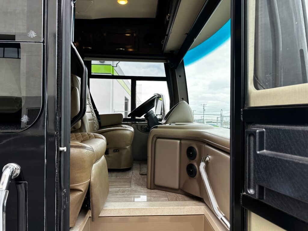 The inside of a bus with the door open