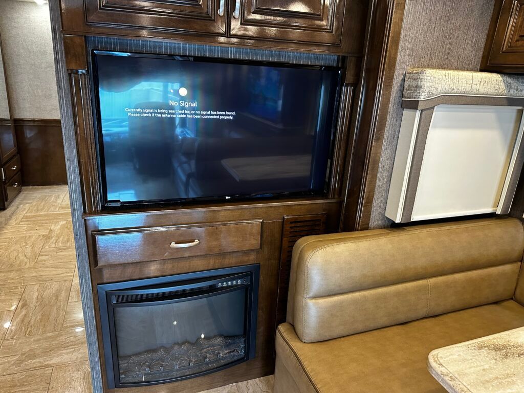 A living room with a fireplace and a flat screen tv.