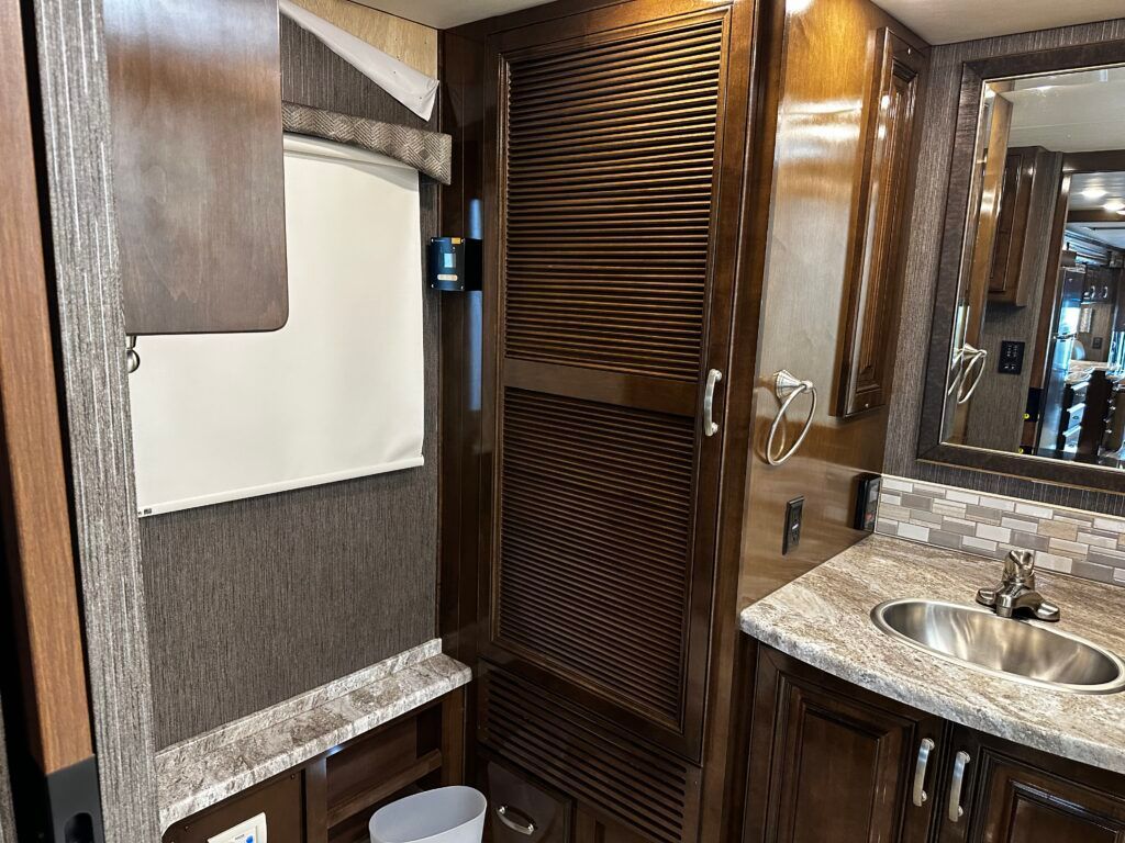 A bathroom with a sink , toilet and mirror.