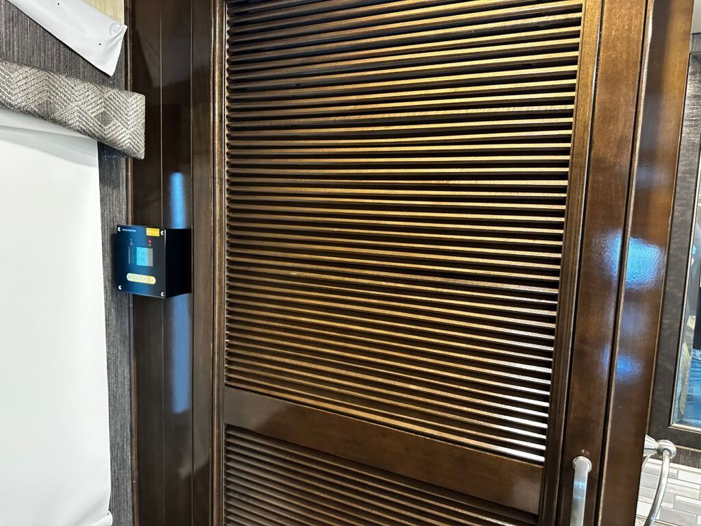 A close up of a wooden door with blinds on it.
