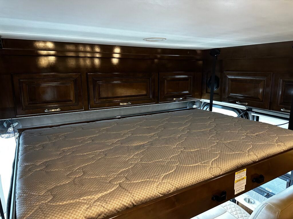 A bed with a mattress on top of it in a room.