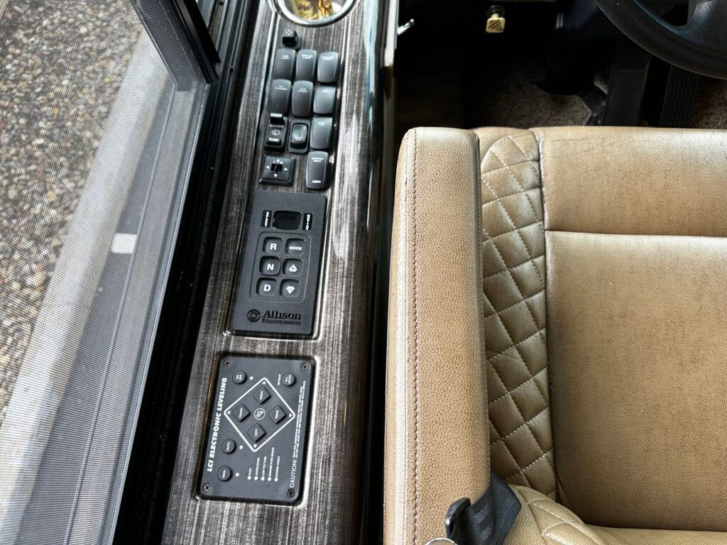 A close up of a car seat with a remote control on it
