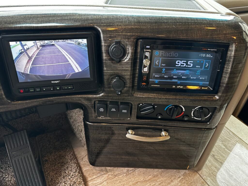 A car dashboard with a rear view camera and a radio.