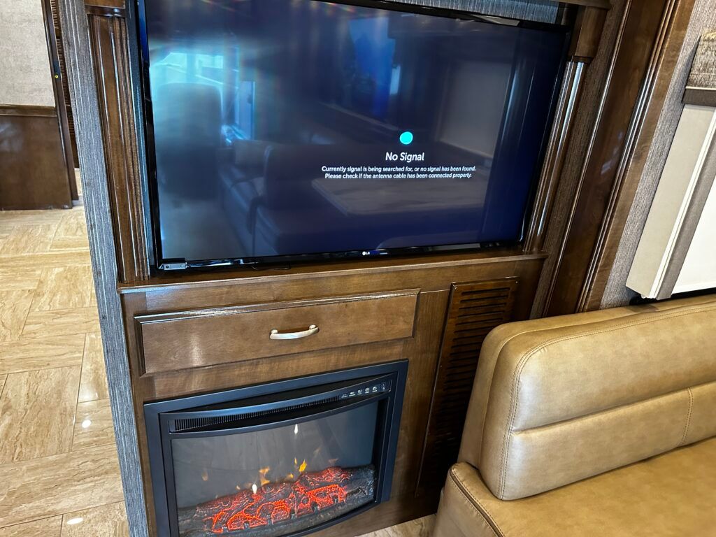A flat screen tv is mounted above a fireplace in a living room.