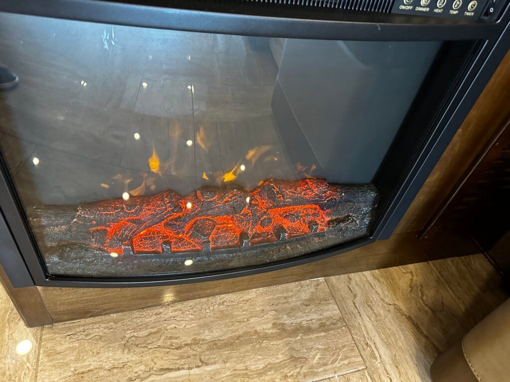 There is a fireplace with a lot of fire in it.