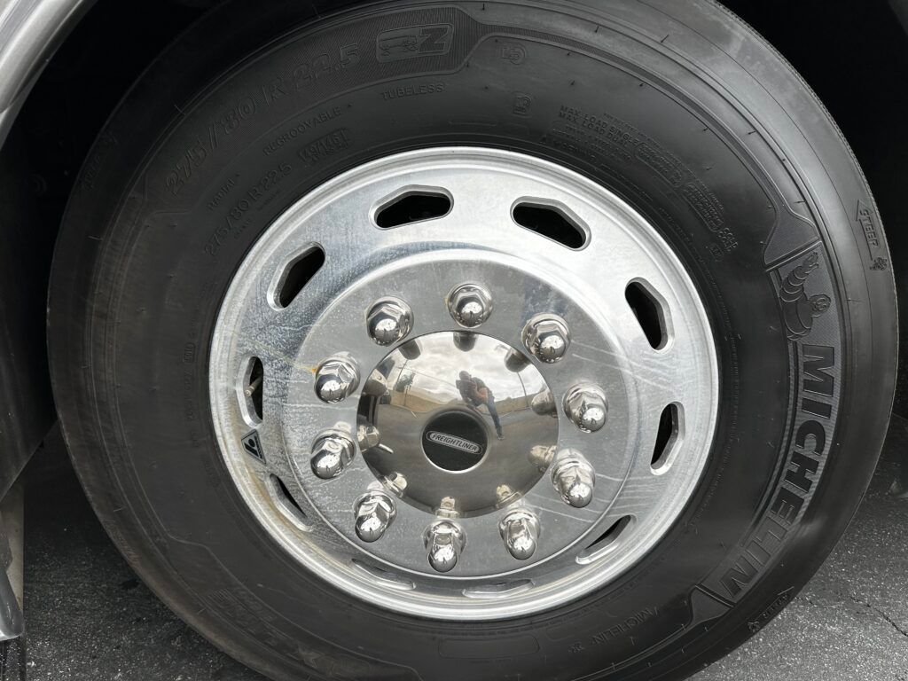 A close up of a tire on a truck with a chrome rim.
