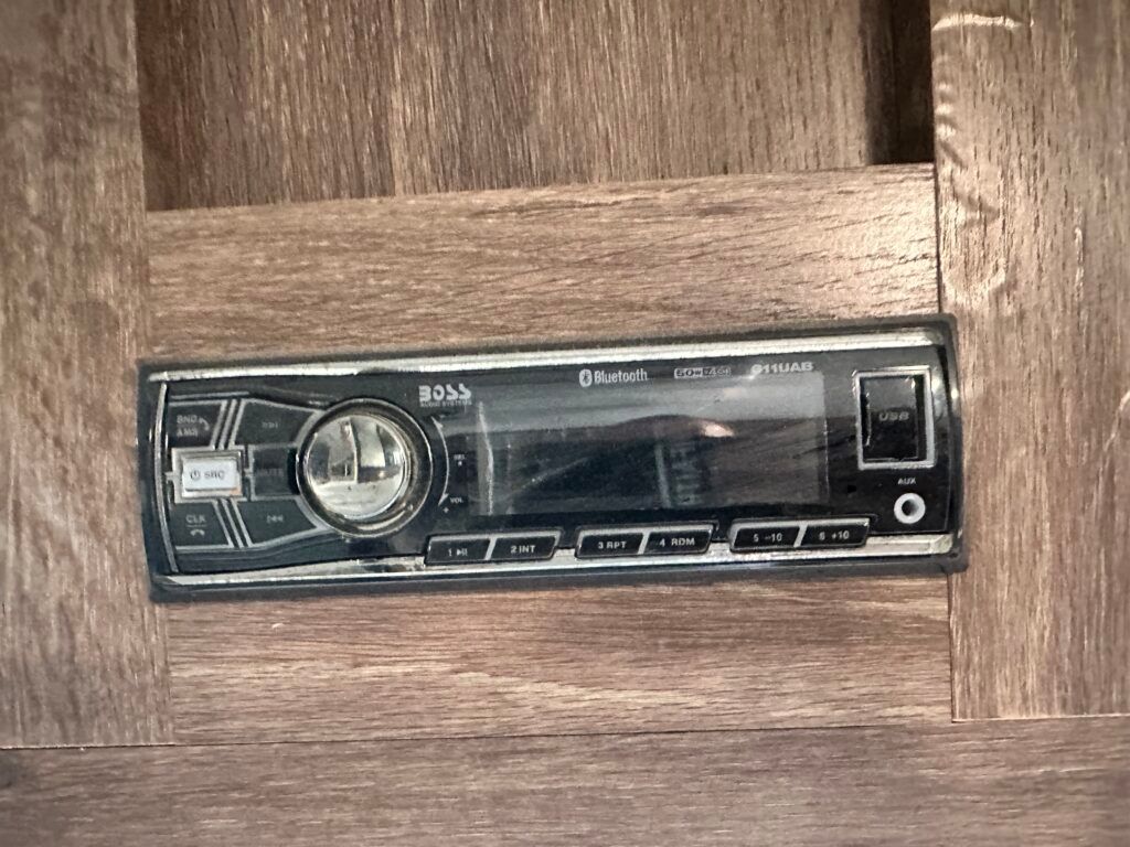 A radio is sitting on top of a wooden table.