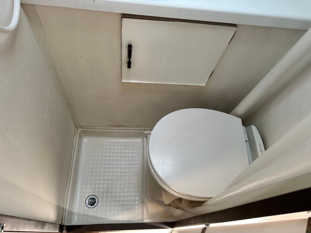 A bathroom with a toilet and a shower stall.