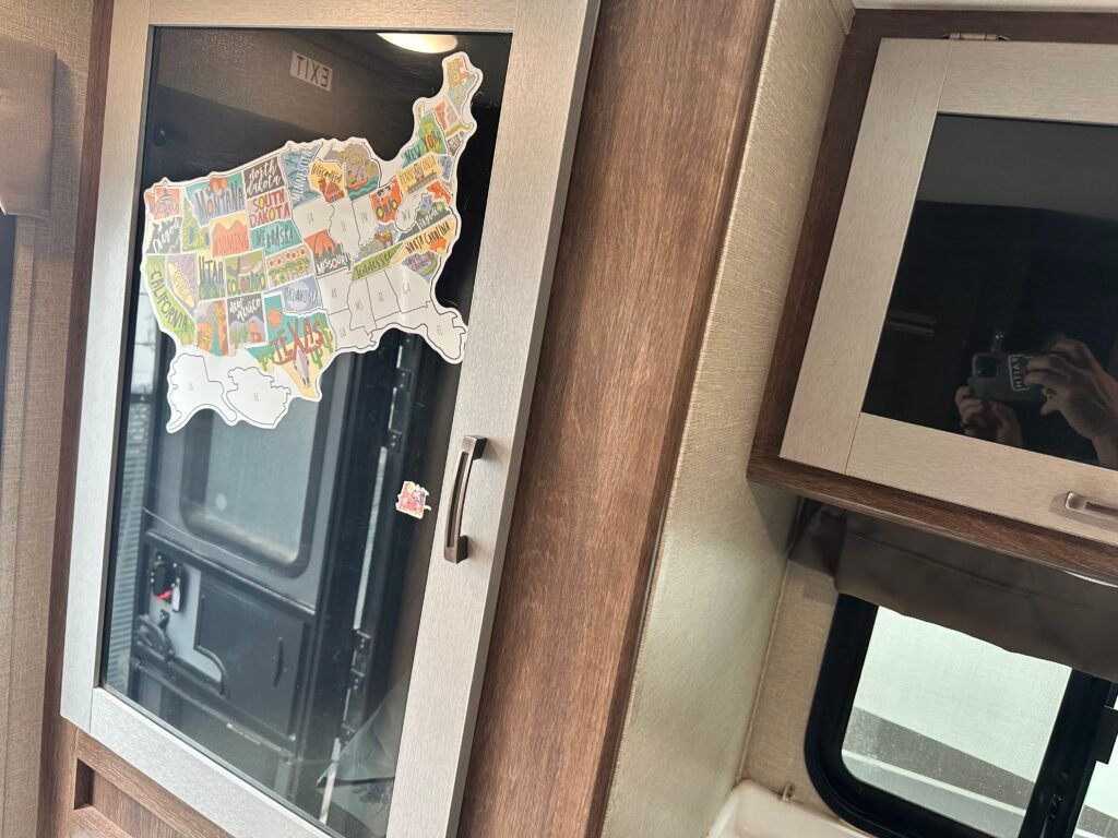 A rv with a map of the united states on the door.