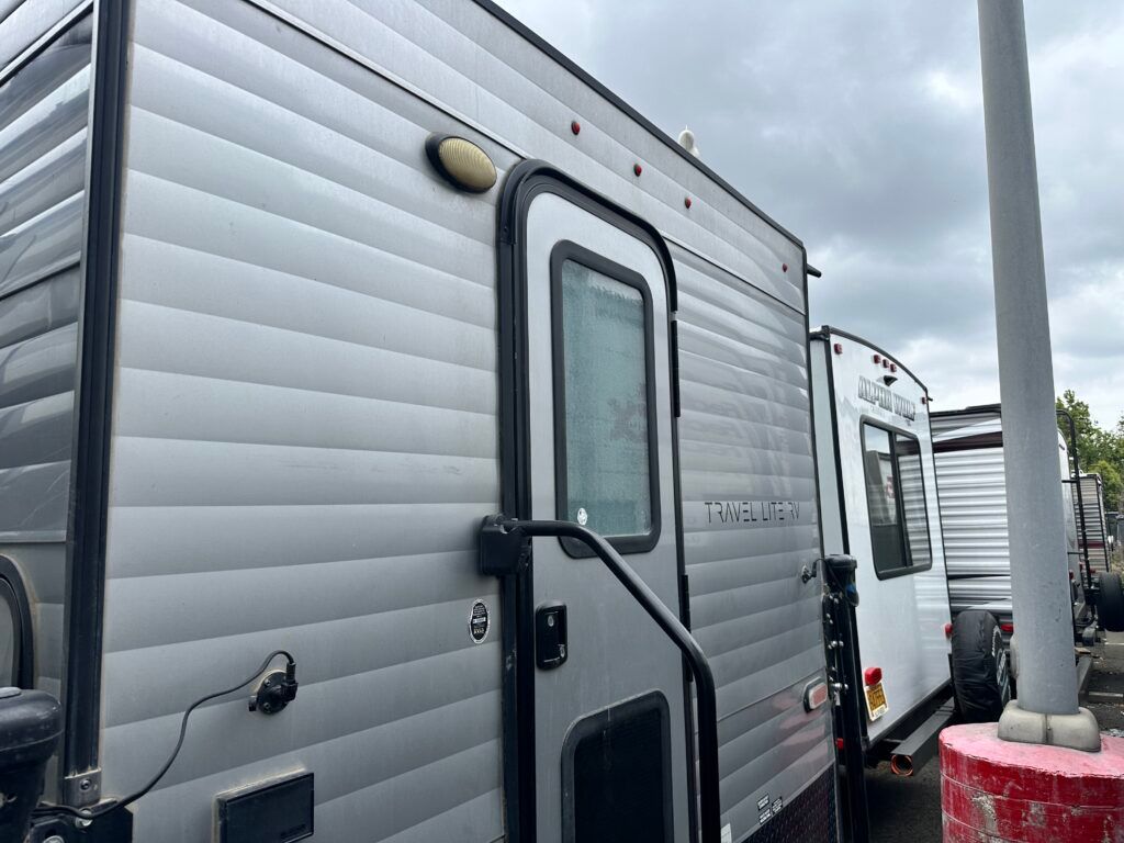 A row of trailers are parked next to each other in a lot.