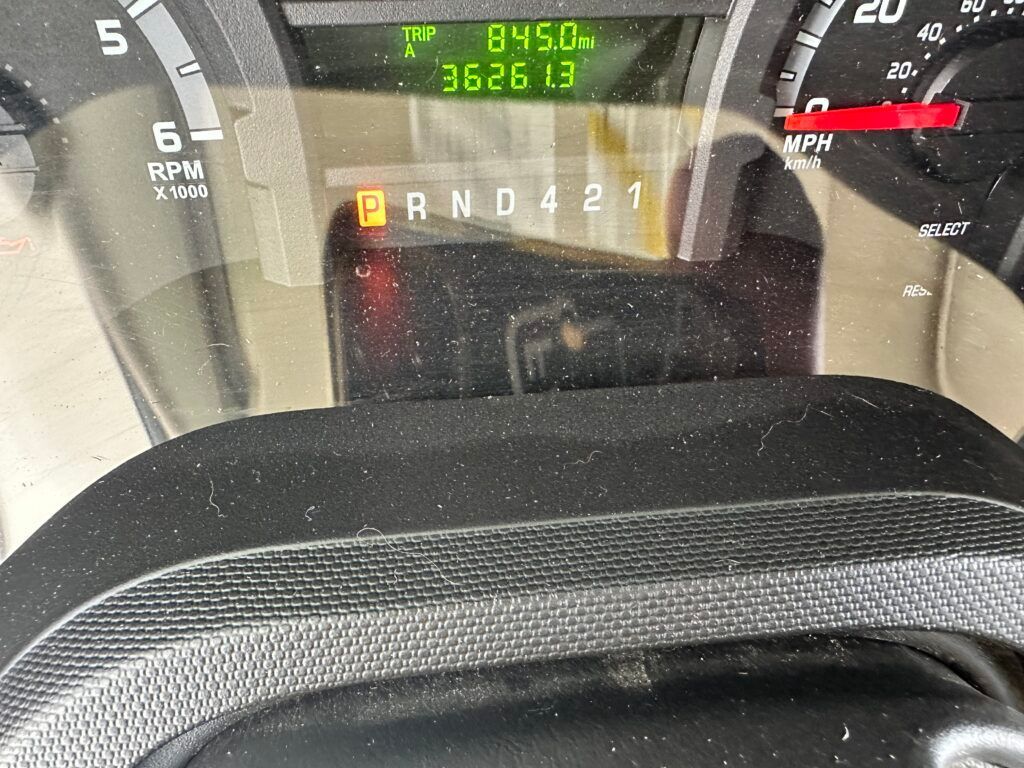 A close up of a car 's dashboard with the numbers 8450 on it