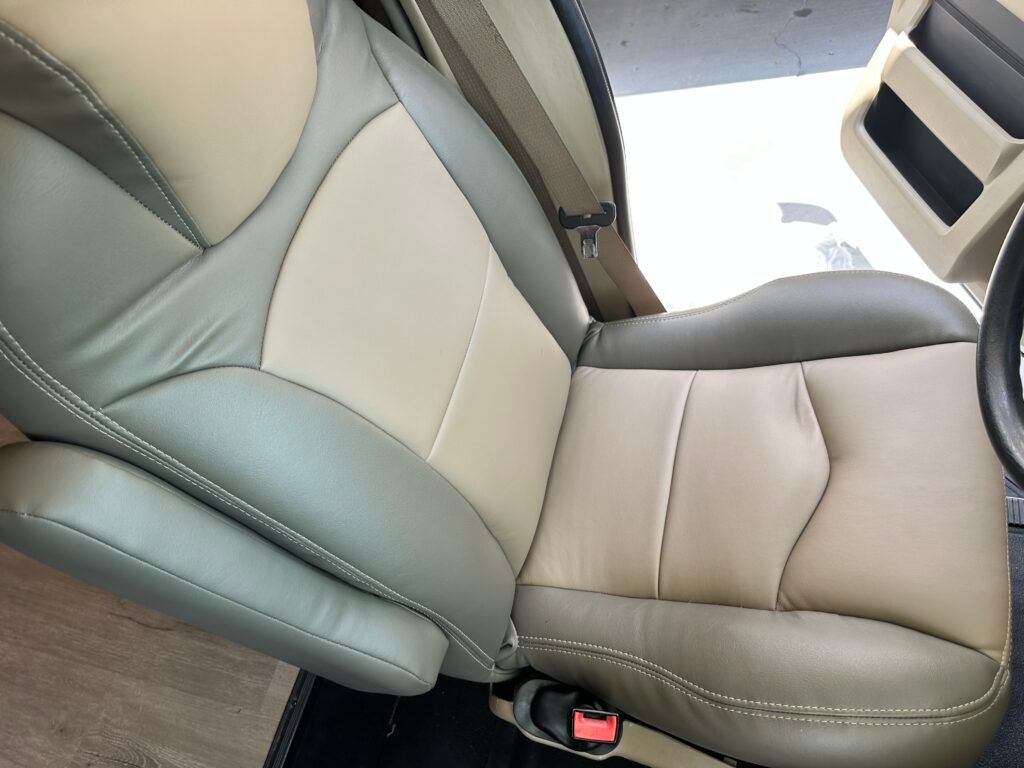 A tan and green leather seat in a car