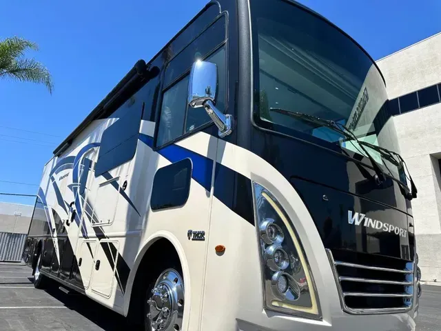 A windstar rv is parked in a parking lot