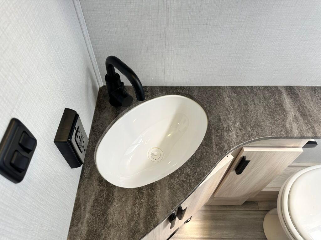 A bathroom with a sink and a toilet.
