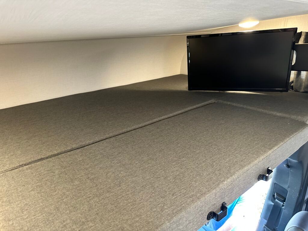 An empty room with a carpeted floor and a ceiling.