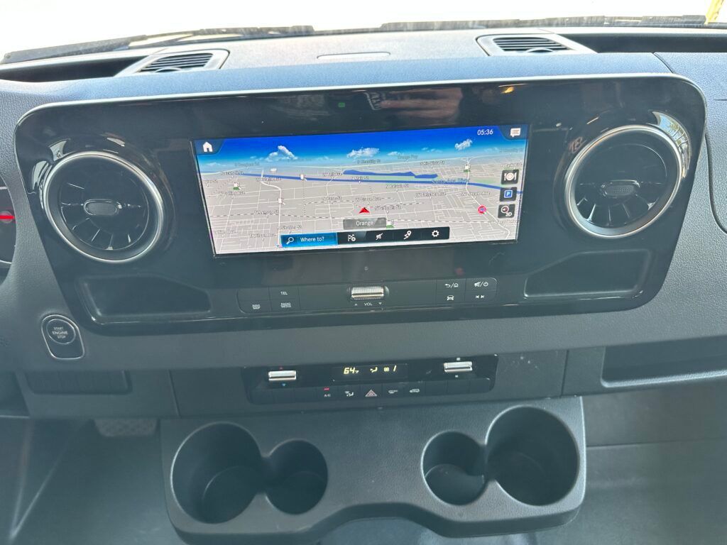 A close up of the dashboard of a car with a gps on it.