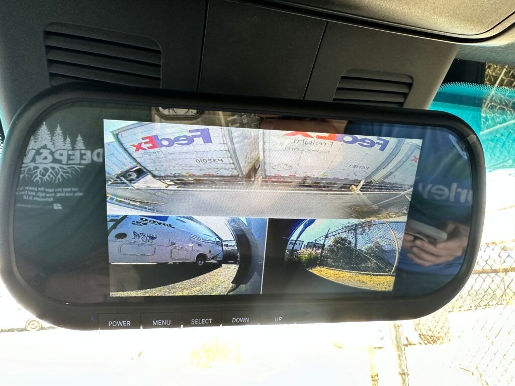 A rear view mirror with a fedex logo on it