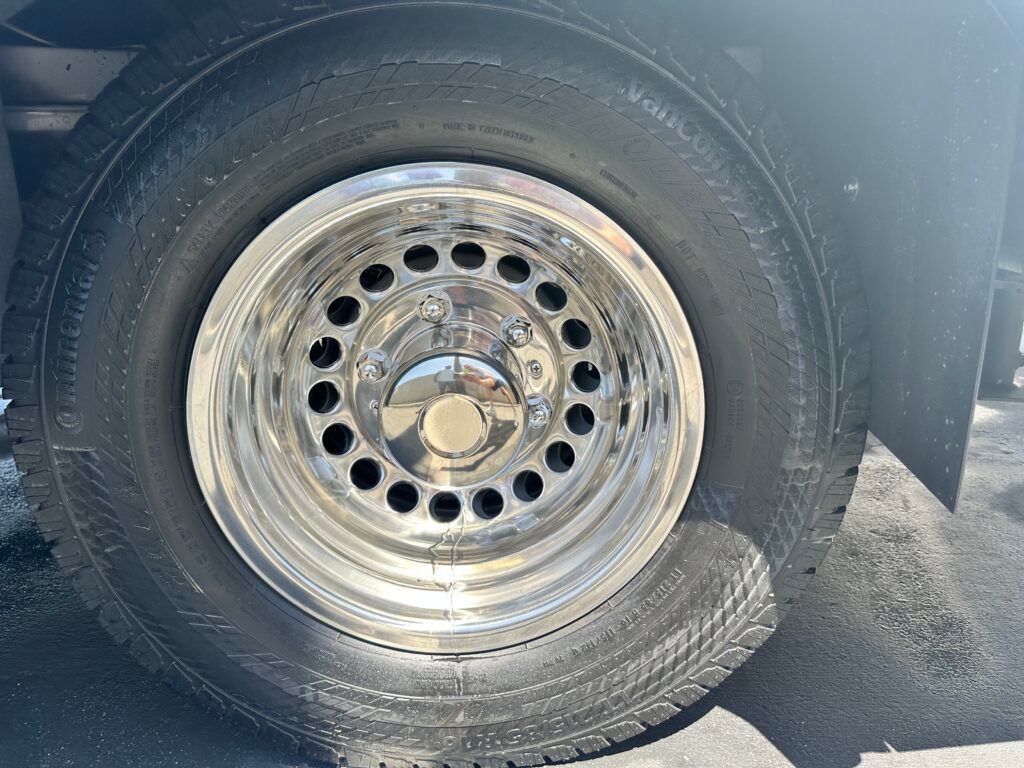 A close up of a car wheel with holes in it.