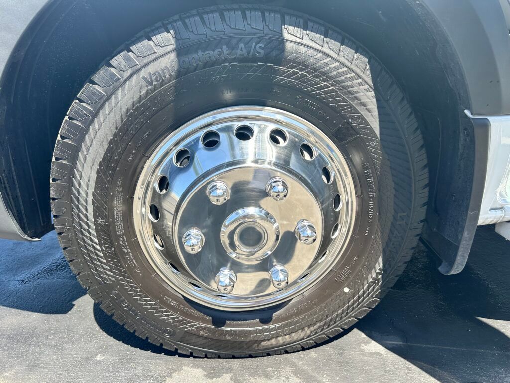 A close up of a truck tire with a chrome rim.