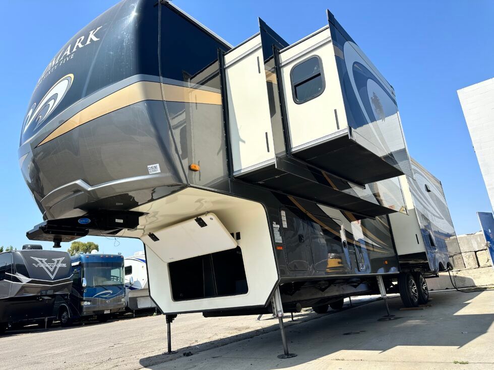 A large rv is parked in a parking lot.