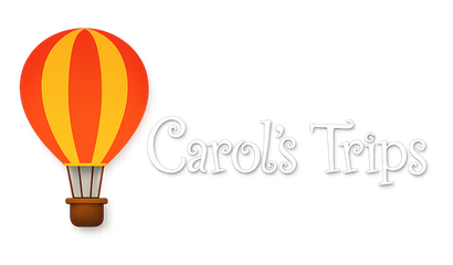 Hot air balloon logo with the text “Carol’s Trips” in white script on a white background