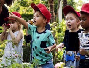 Montessori children exploring nature balancing routines with new experiences.
