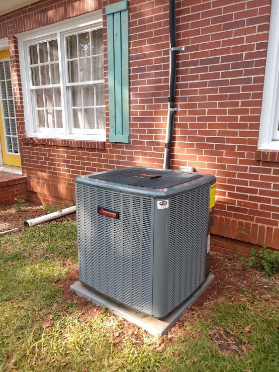 Close-up of a metal cooling fan positioned next to a copper tube heat exchanger with cooling fins.