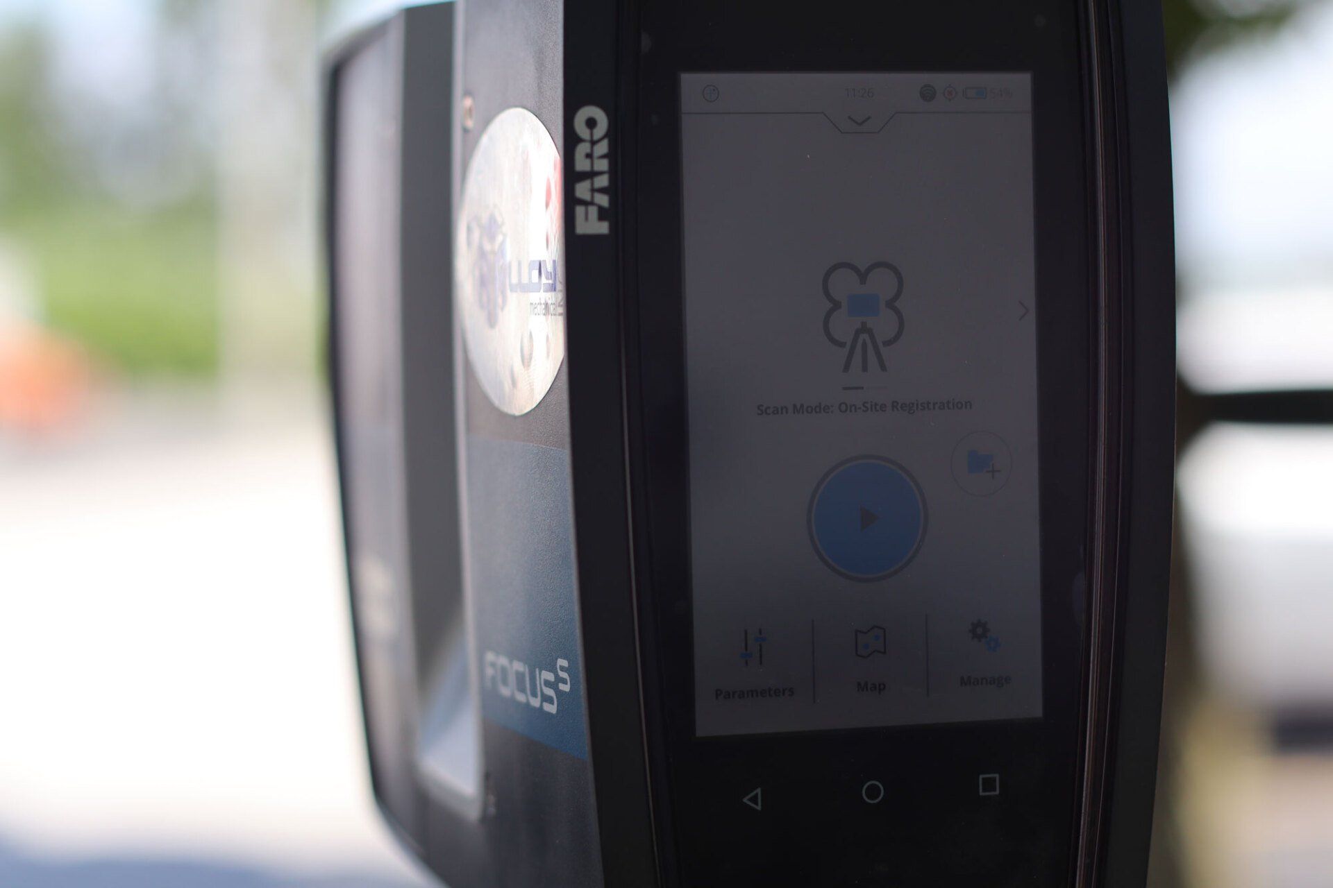 a cell phone is sitting on top of a parking meter .