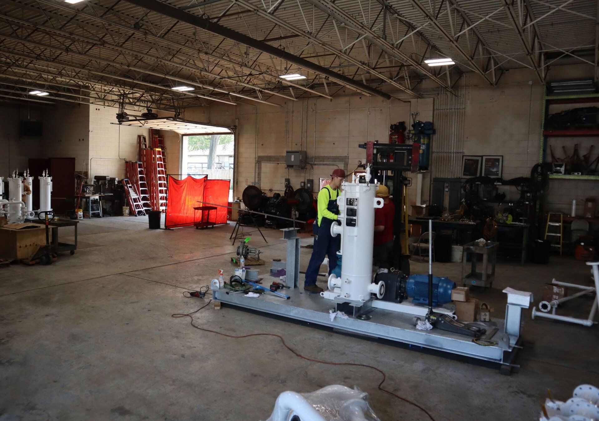 a man is working on a machine in a factory .