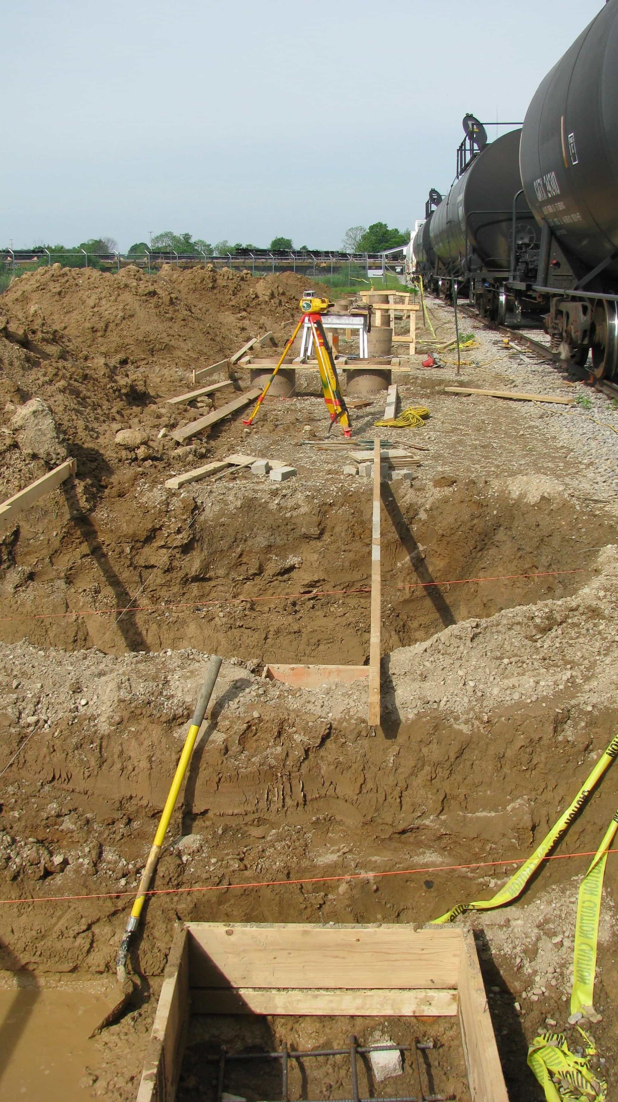 a construction site with a train in the background.